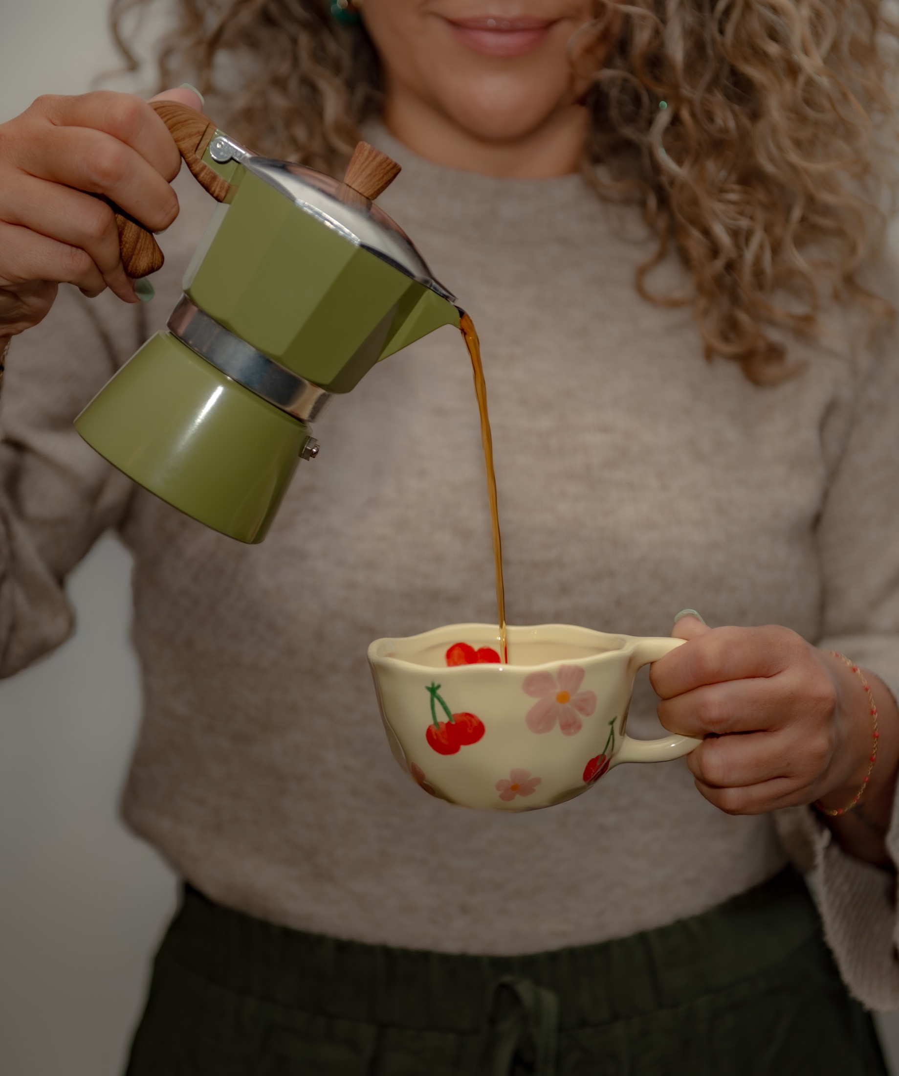Coffee entrepreneur pouring a fresh cup during a lifestyle brand photography session