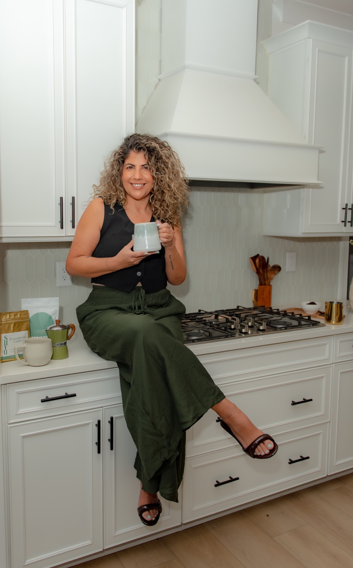 Coffee company founder holding her product in a bright lifestyle kitchen