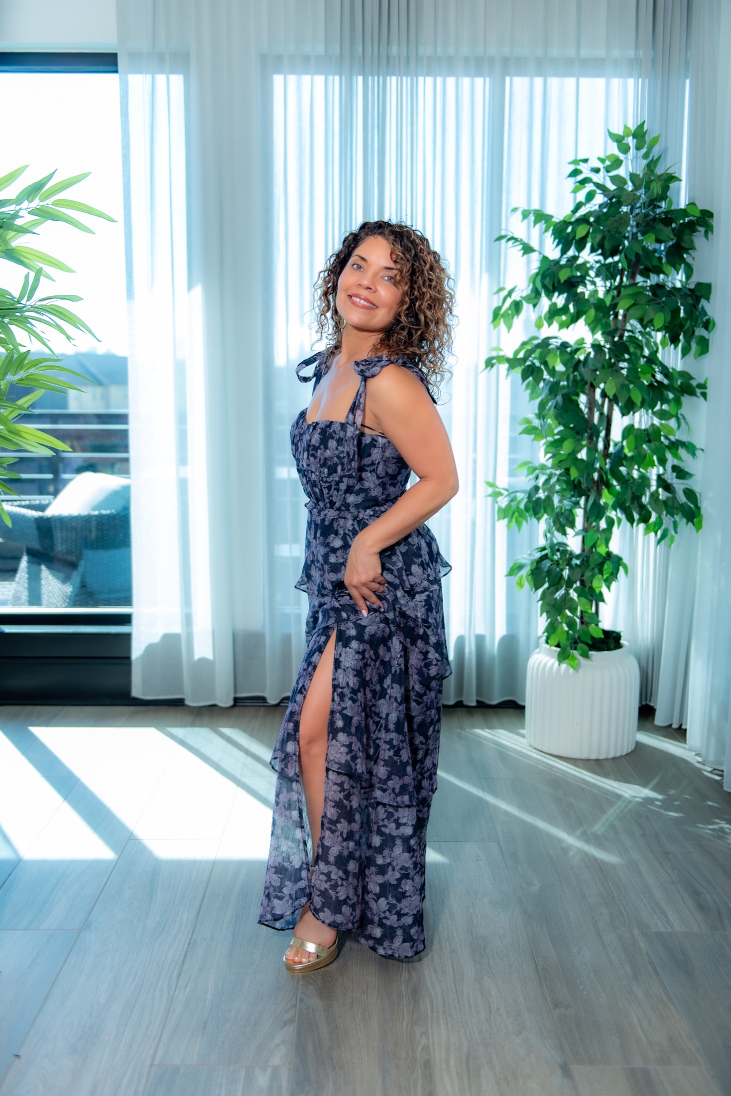 Full-length personal brand portrait of a woman entrepreneur in a floral dress