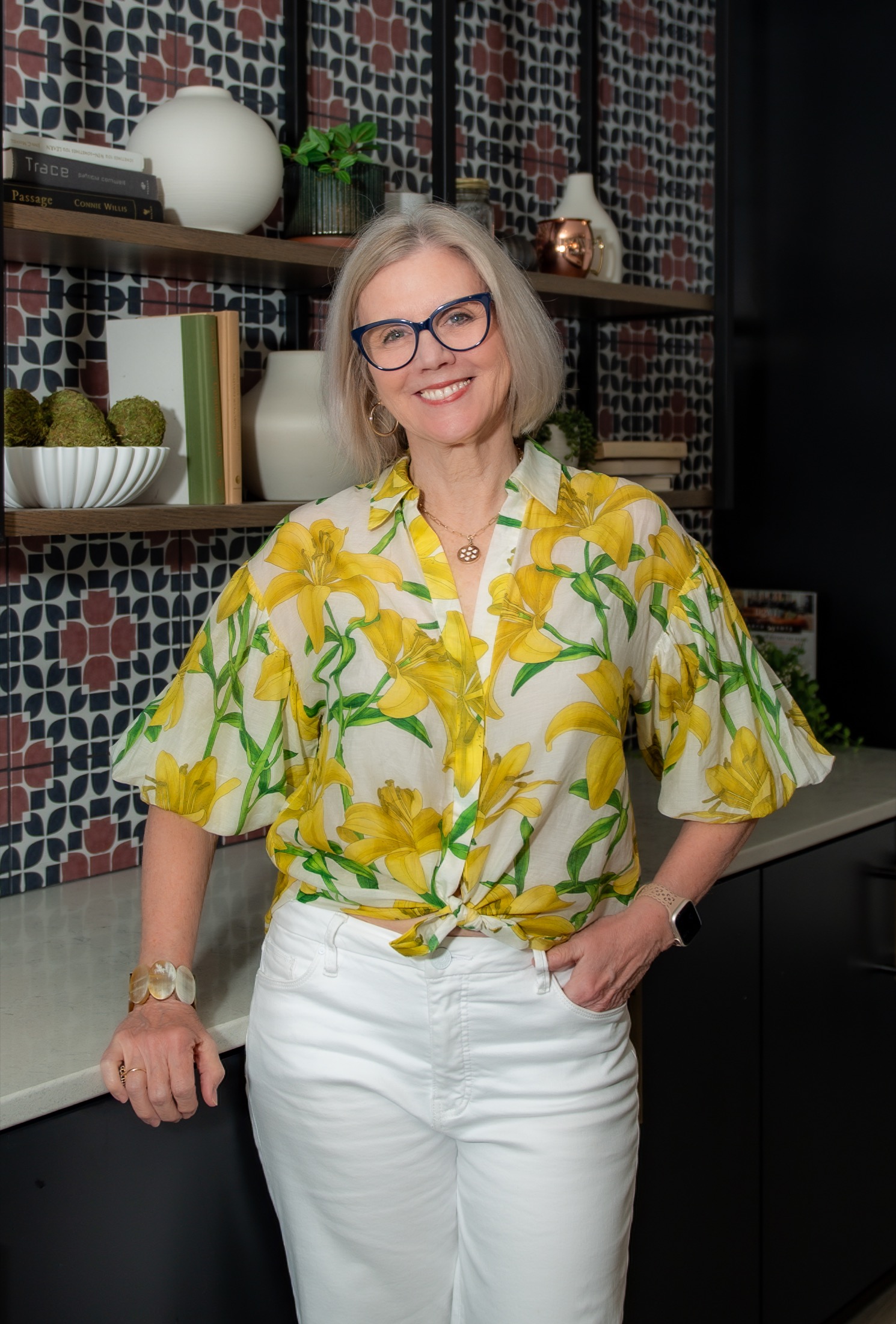 Businesswoman in a floral blouse and blue glasses photographed for her personal brand