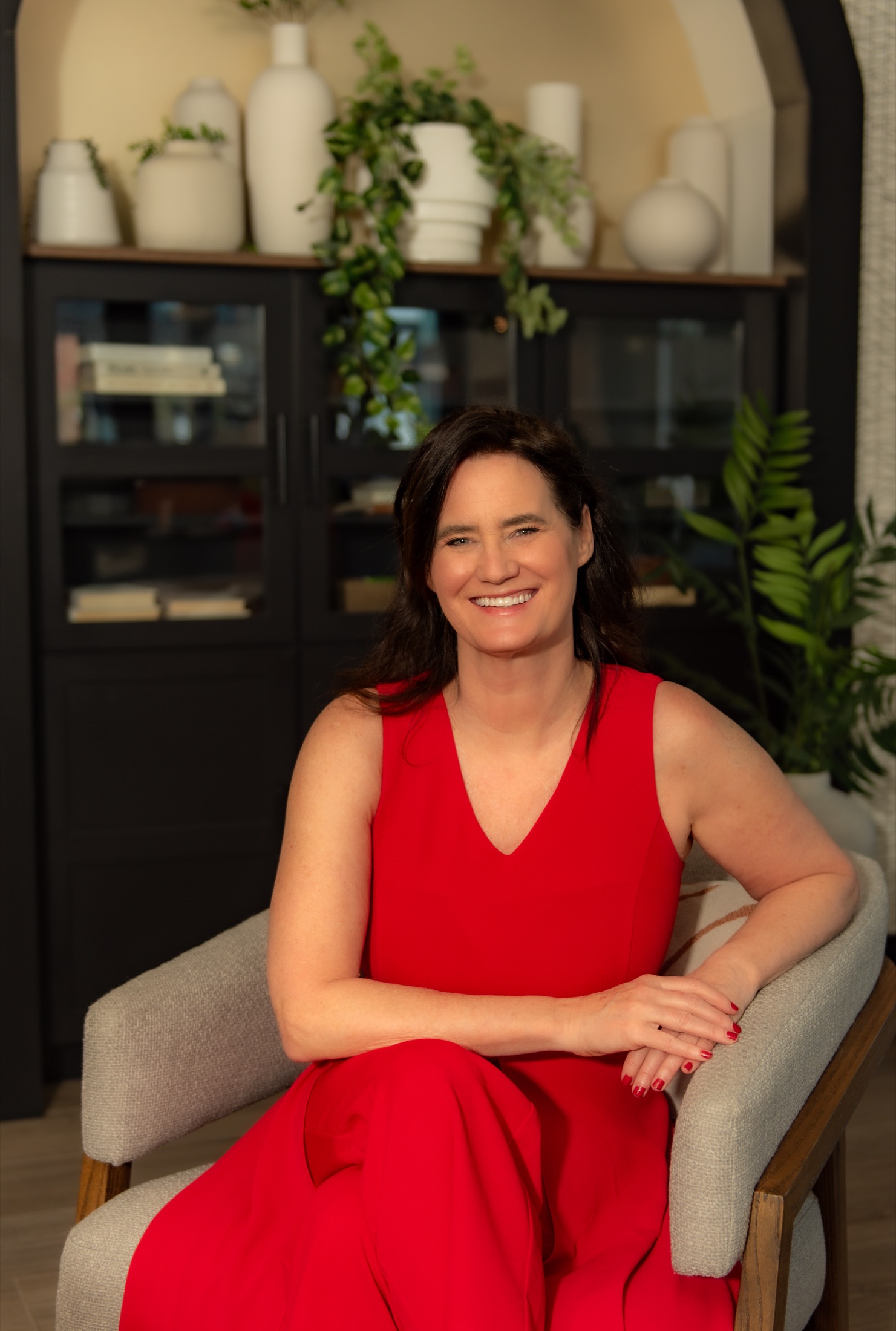 Businesswoman in red seated for a polished professional portrait