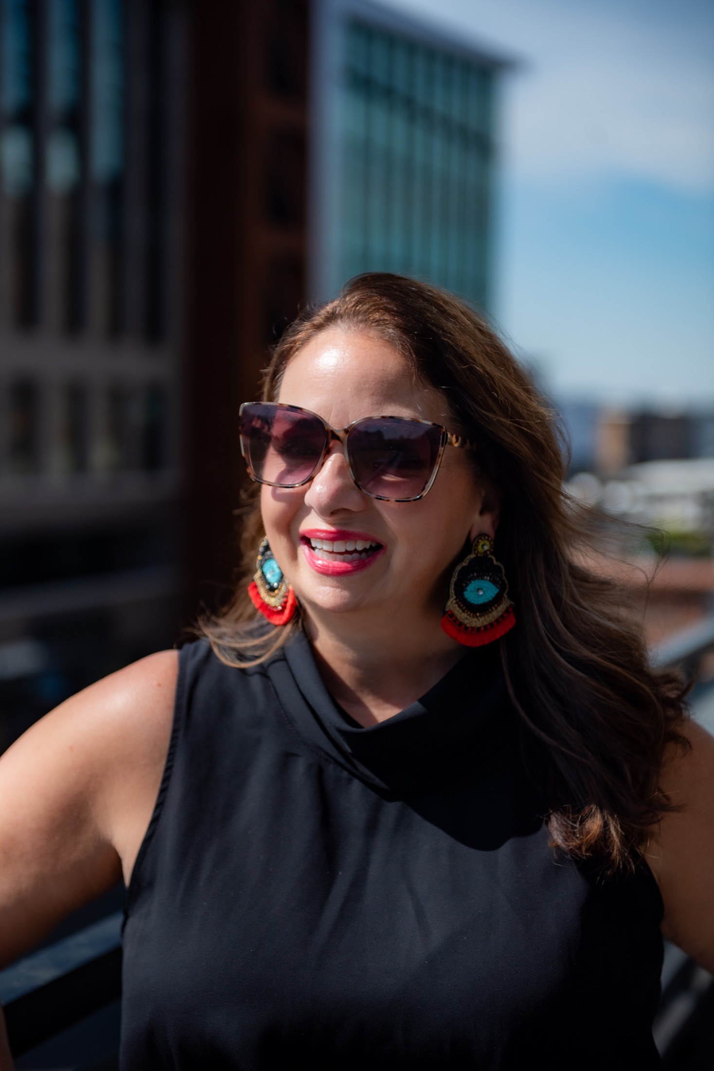 Outdoor personal brand portrait of a businesswoman wearing sunglasses