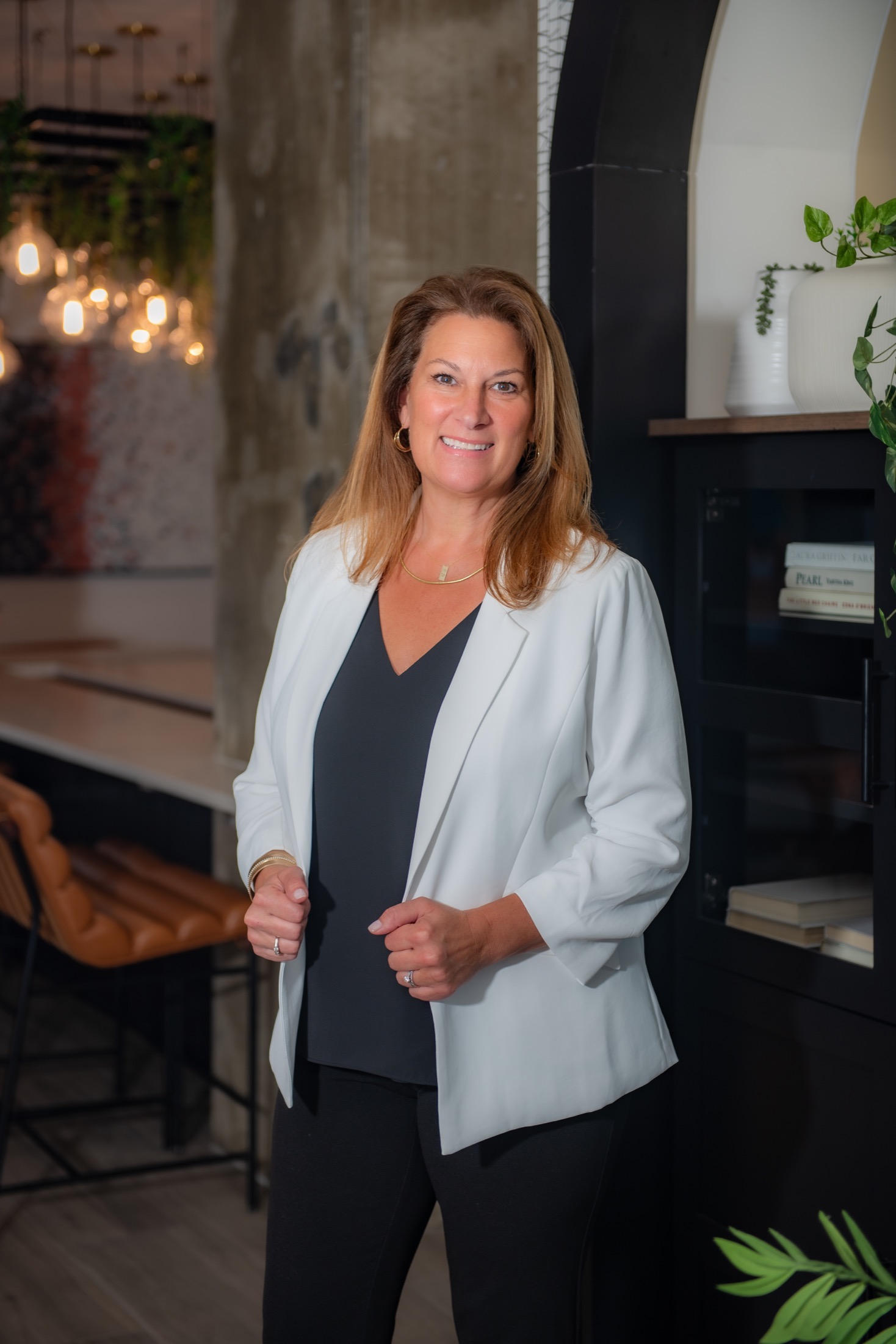 Executive portrait of a businesswoman wearing a white blazer