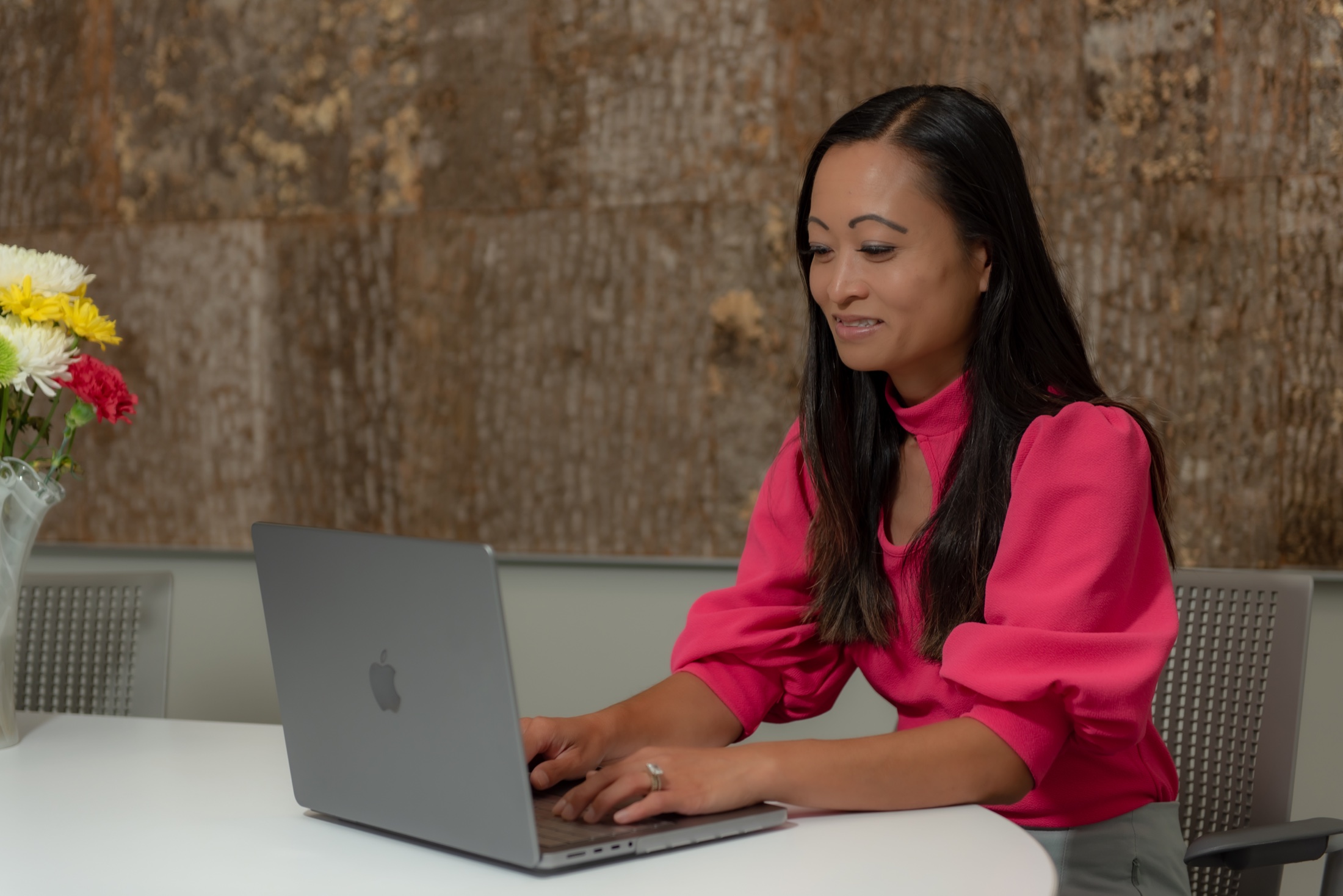 Businesswoman working at her laptop during a South Florida brand session