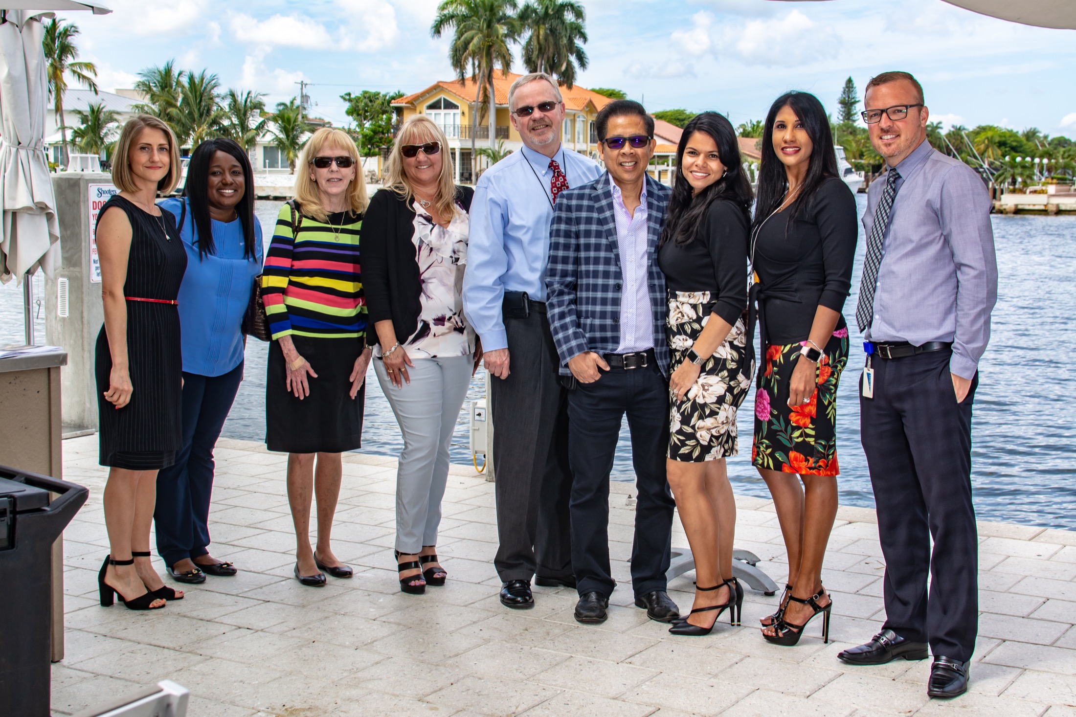 Large company team portrait beside the South Florida waterfront