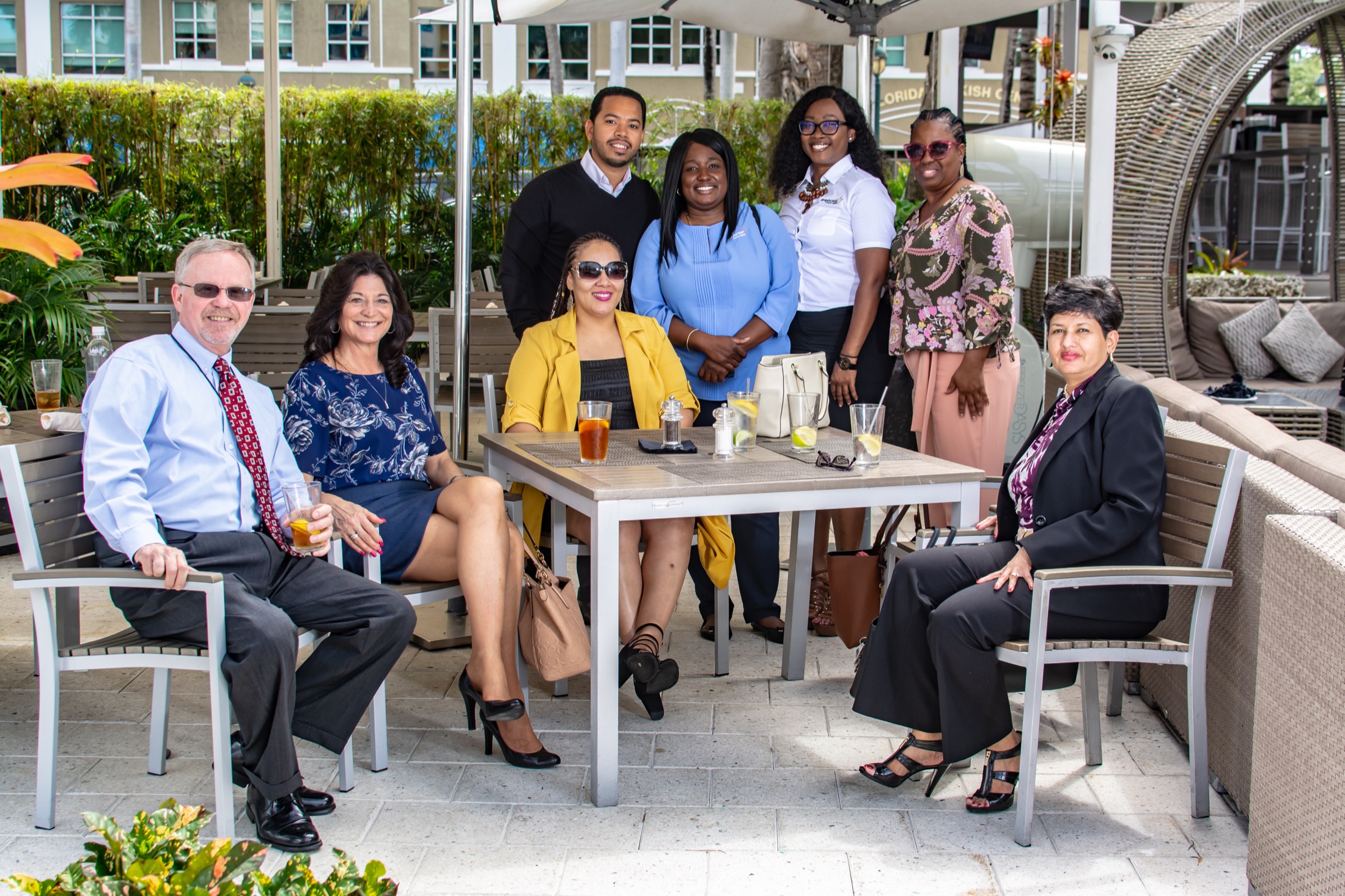 Colleagues gathered around a table at an outdoor business event