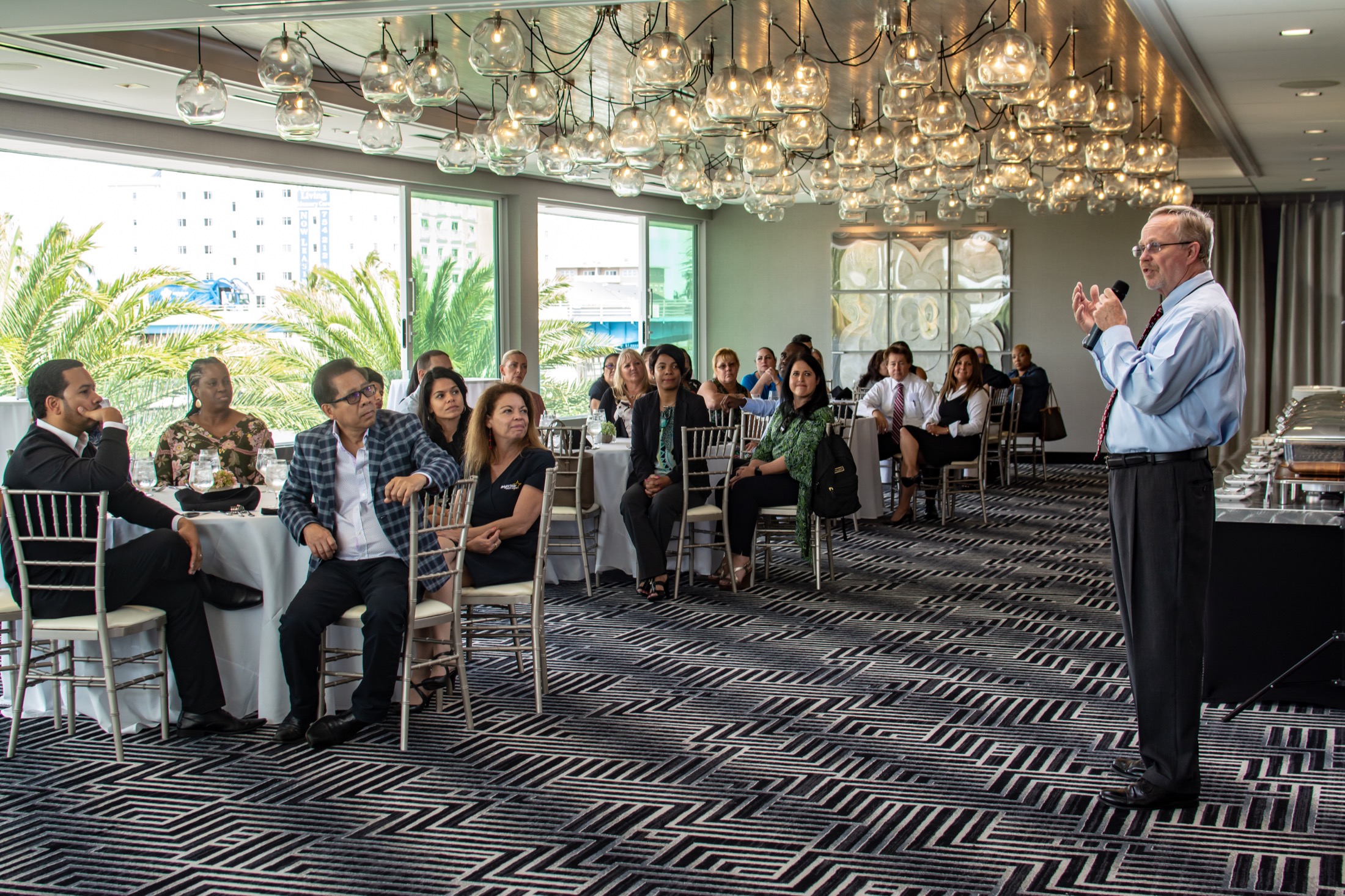 Executive speaking to employees during a corporate luncheon