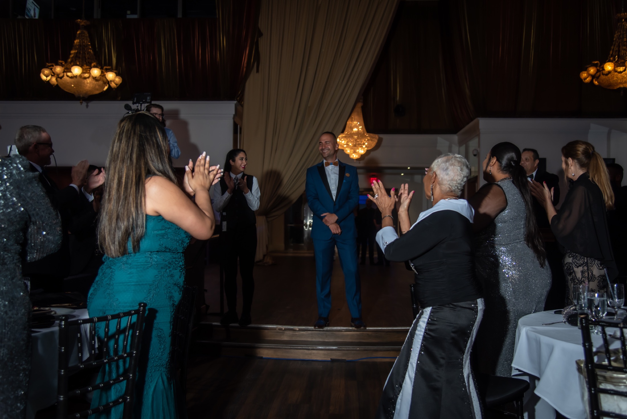 Honoree receiving applause during a company recognition event