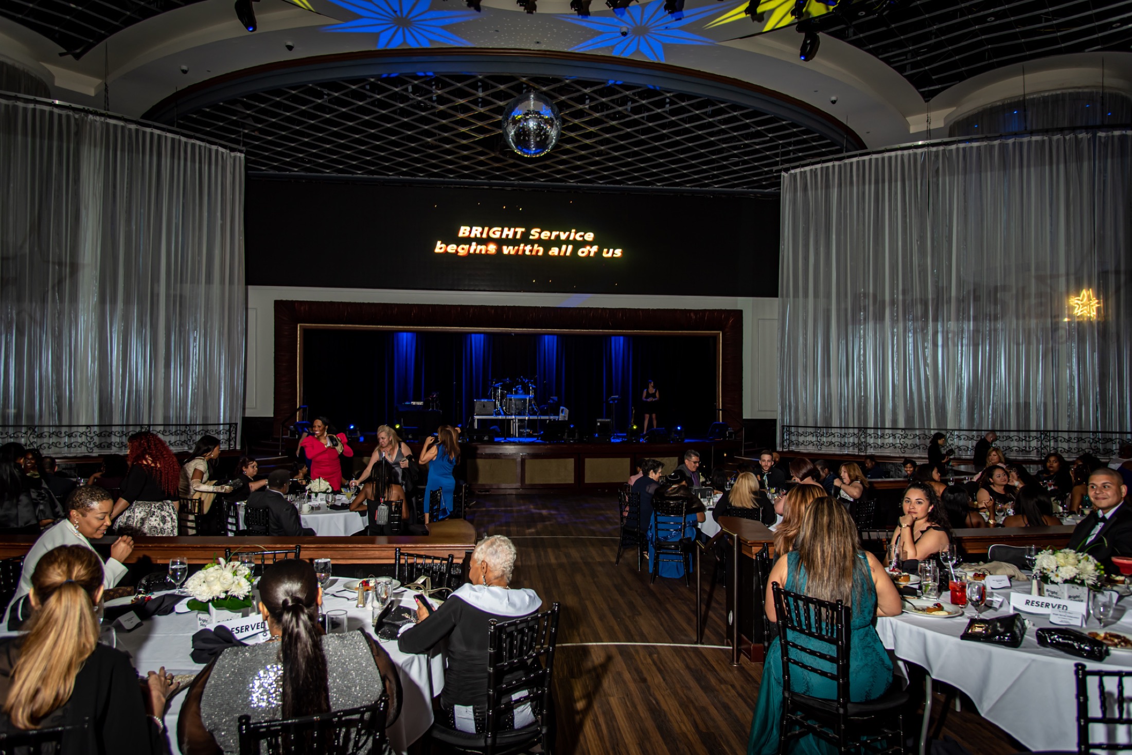 Wide view of a company gala venue and seated attendees