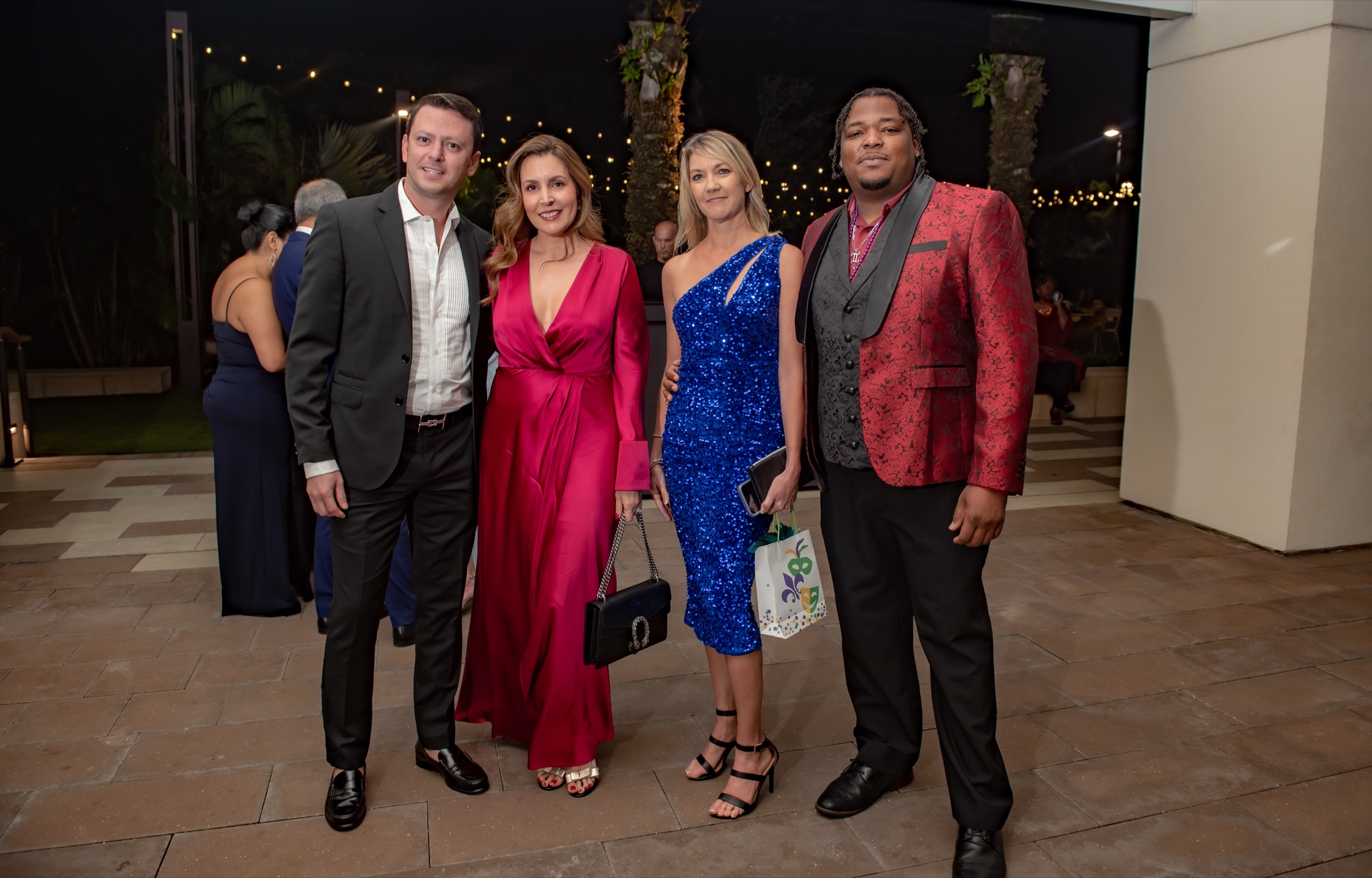 Four guests posing during an outdoor corporate reception