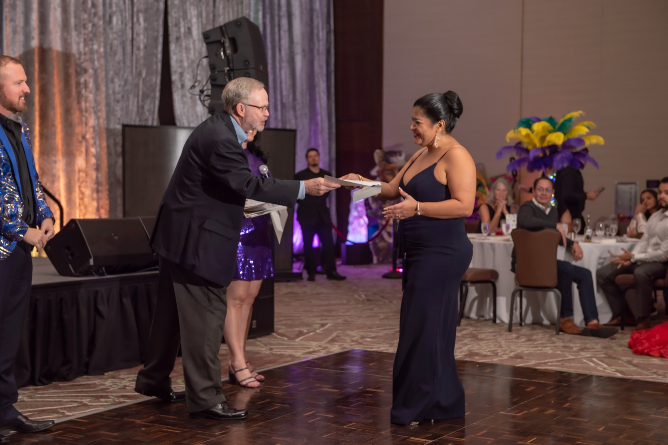 Recognition moment on stage during a corporate awards event