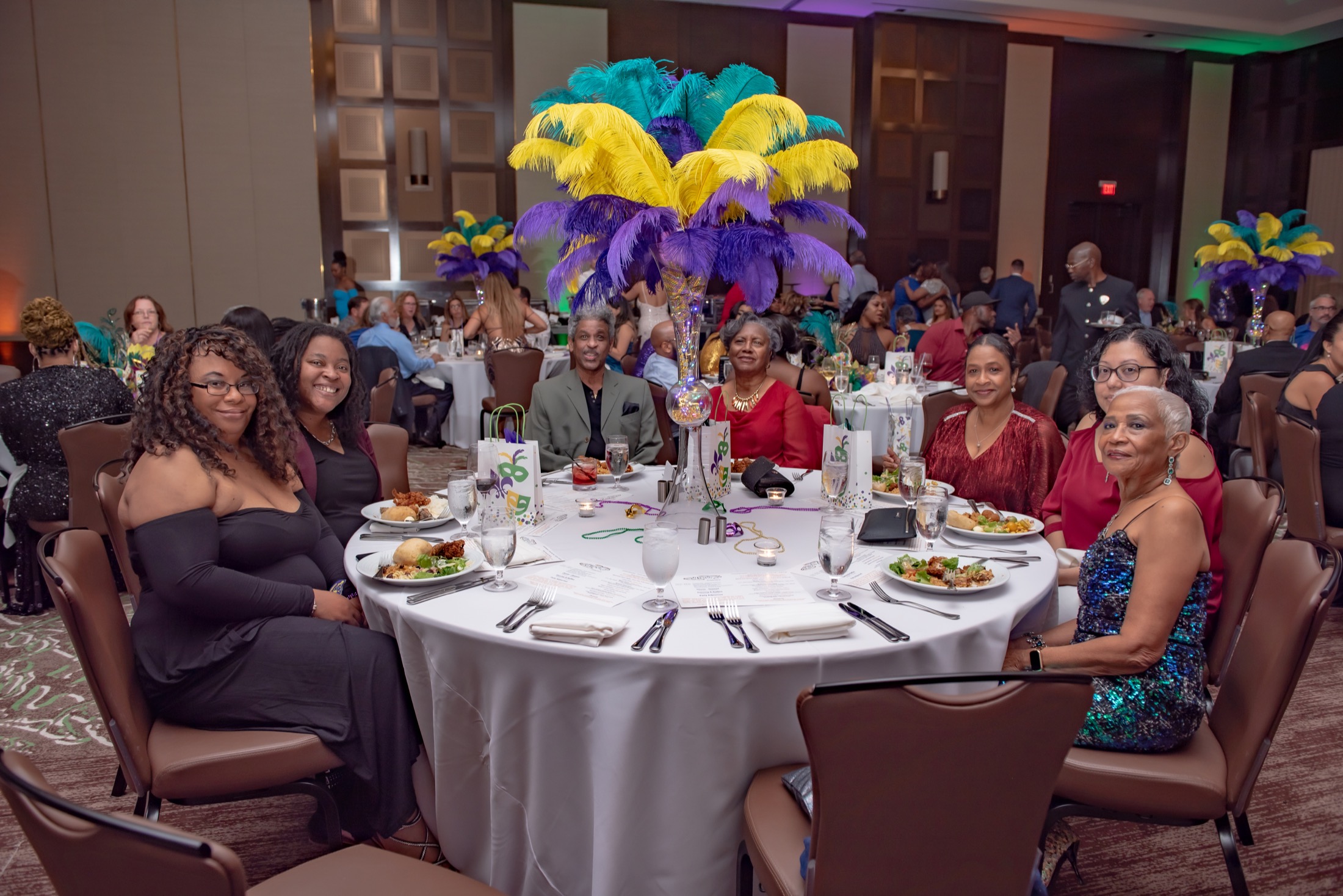 Company gala guests gathered around a decorated dinner table